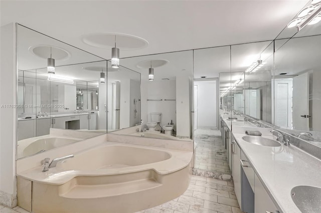 4000 Towerside Ter Unit 302, Miami, FL 33138 - bathroom featuring a garden tub, a bidet, double vanity, marble look tiles, and toilet