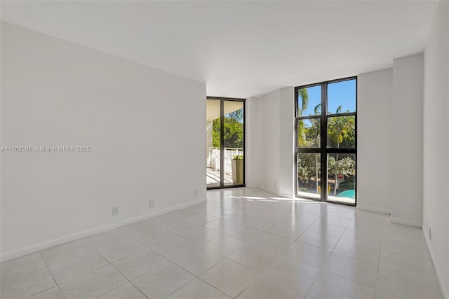 4000 Towerside Ter Unit 302, Miami, FL 33138 - spare room with expansive windows, baseboards, and light tile patterned flooring