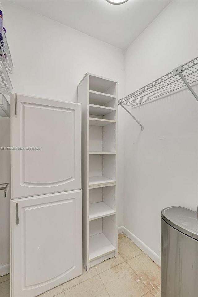 4000 Towerside Ter Unit 302, Miami, FL 33138 - walk in closet with light tile patterned floors
