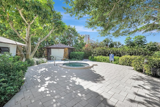 4000 Towerside Ter Unit 302, Miami, FL 33138 - view of patio / terrace with an outbuilding and an in-ground hot tub