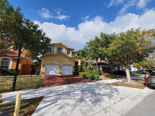 11009 NW 80th Ln, Doral, FL 33178 - mediterranean / spanish house featuring decorative driveway, stucco siding, and an attached garage