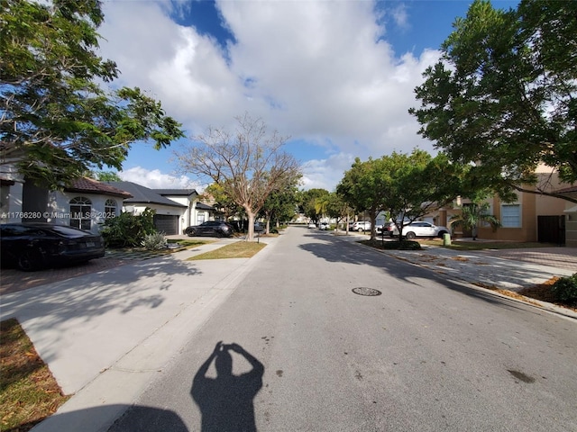 11009 NW 80th Ln, Doral, FL 33178 - view of asphalt road featuring sidewalks and a residential view