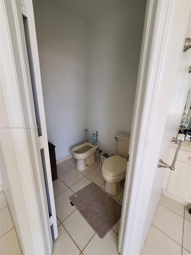 11009 NW 80th Ln, Doral, FL 33178 - bathroom with a bidet and tile patterned floors
