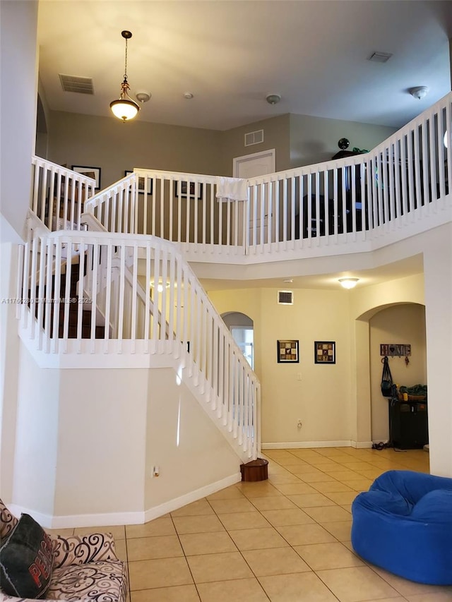 11009 NW 80th Ln, Doral, FL 33178 - stairs featuring tile patterned floors, arched walkways, and a high ceiling