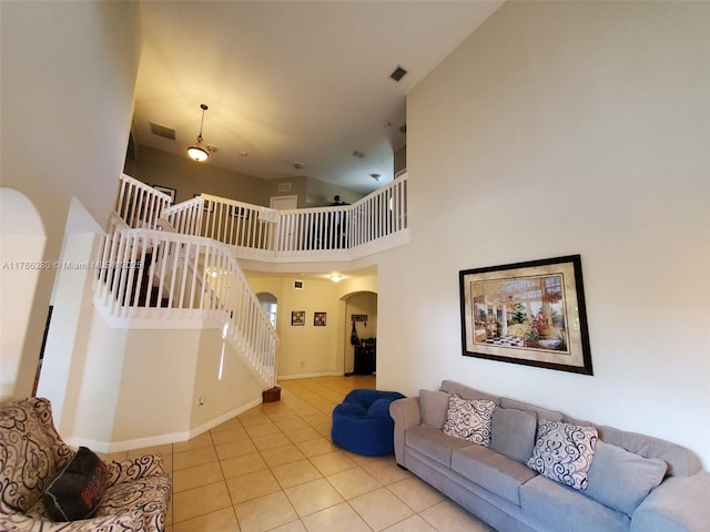 11009 NW 80th Ln, Doral, FL 33178 - living room featuring arched walkways, stairs, tile patterned floors, and a high ceiling