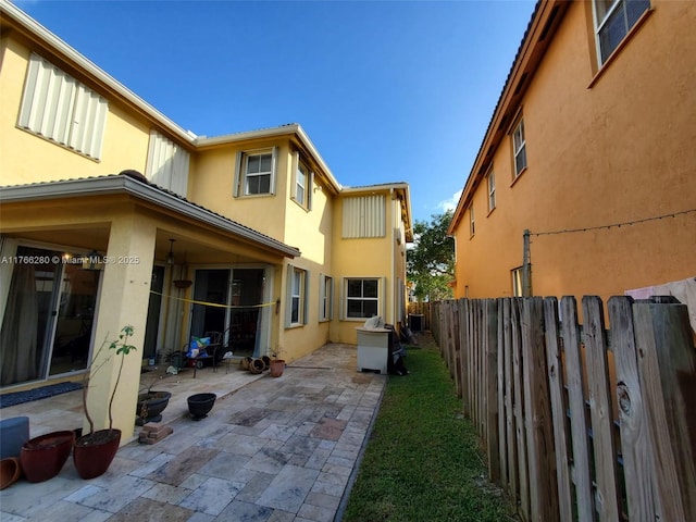 11009 NW 80th Ln, Doral, FL 33178 - rear view of property with stucco siding, a patio area, and a fenced backyard