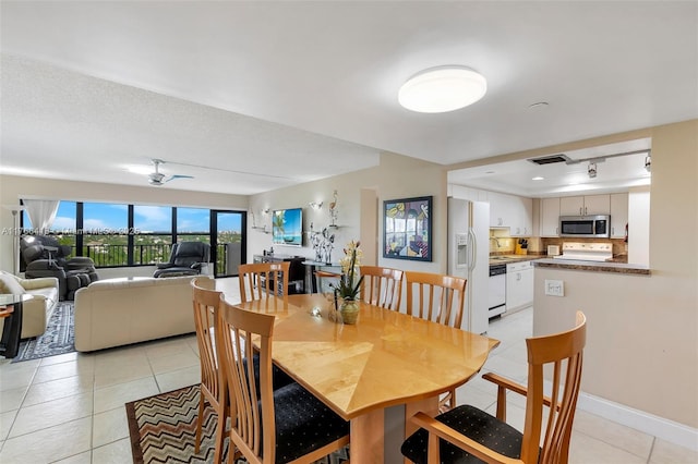 dining area with light tile patterned floors and baseboards