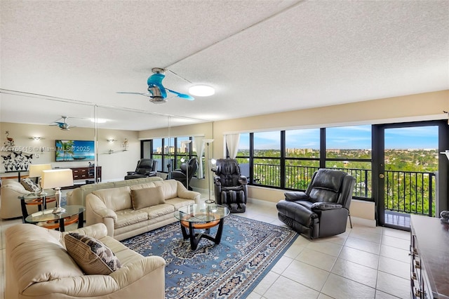 living room featuring light tile patterned flooring, a textured ceiling, and ceiling fan