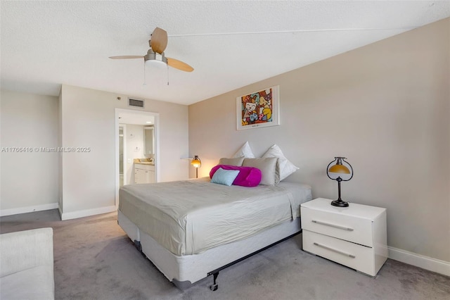 carpeted bedroom featuring a ceiling fan, baseboards, visible vents, a textured ceiling, and connected bathroom