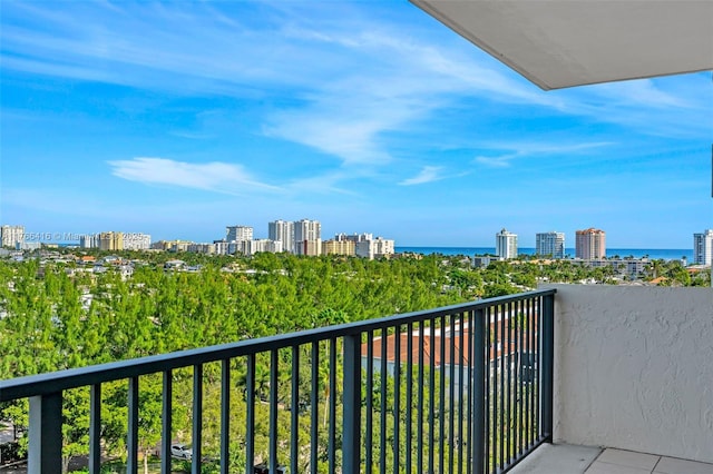 balcony featuring a view of city and a water view