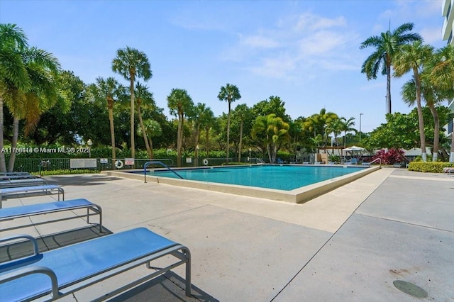 pool featuring a patio area and fence