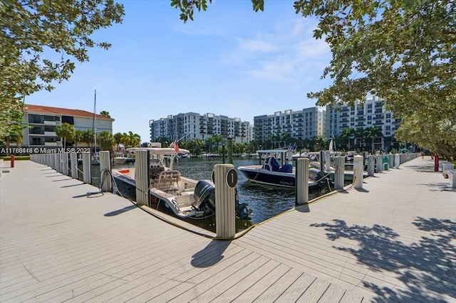 dock area featuring a city view and a water view