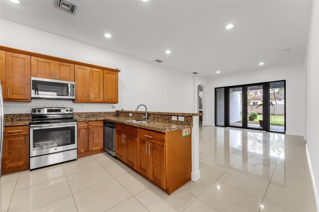 14555 SW 32nd St, Miami, FL 33175 - kitchen featuring visible vents, brown cabinets, stainless steel appliances, arched walkways, and a sink