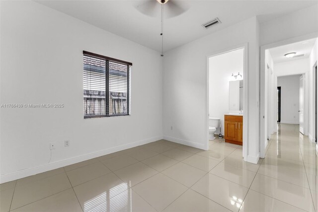 14555 SW 32nd St, Miami, FL 33175 - unfurnished bedroom with light tile patterned floors, visible vents, baseboards, and connected bathroom