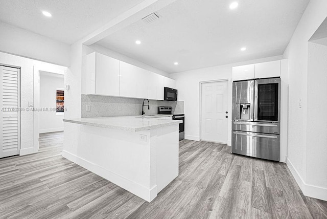 400 NW 117th St, Miami, FL 33168 - kitchen featuring modern cabinets, appliances with stainless steel finishes, white cabinets, and light wood finished floors