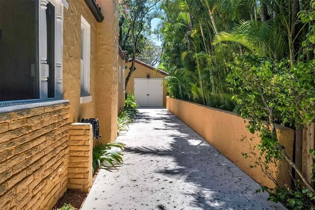 view of side of home featuring a tile roof and stucco siding