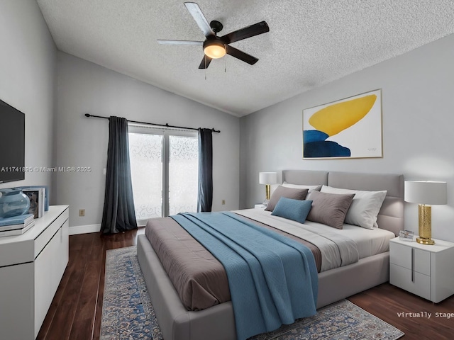 bedroom with a ceiling fan, a textured ceiling, dark wood finished floors, and lofted ceiling