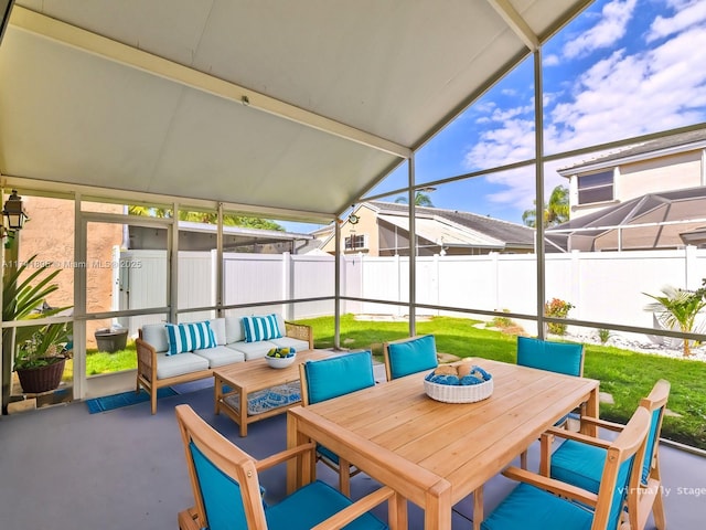 sunroom / solarium with an outdoor living space and outdoor dining space