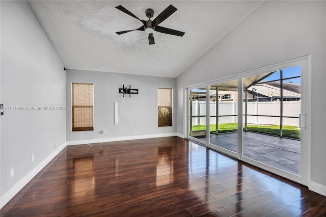 spare room with baseboards, a ceiling fan, wood finished floors, and a textured ceiling