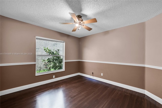 unfurnished room with baseboards, a ceiling fan, wood finished floors, and a textured ceiling