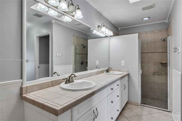 bathroom with a shower stall, tile patterned floors, visible vents, and a sink