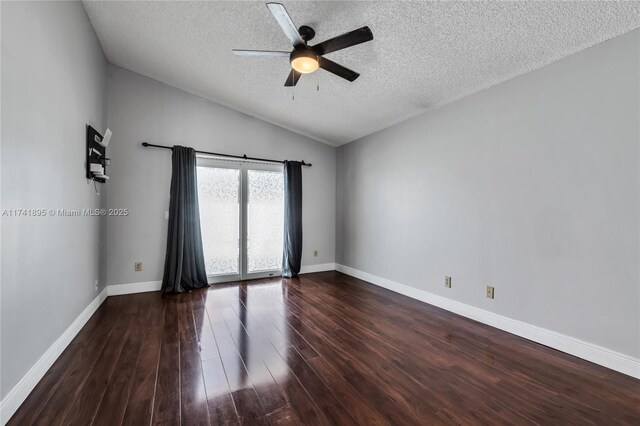 empty room featuring baseboards, vaulted ceiling, a textured ceiling, ceiling fan, and wood finished floors