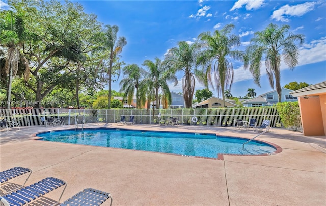 pool with fence and a patio