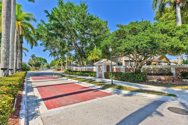 view of community featuring fence and a residential view