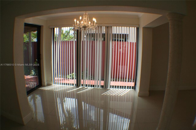 8918 SW 5th Ter, Miami, FL 33174 - tiled empty room with arched walkways, baseboards, and a chandelier