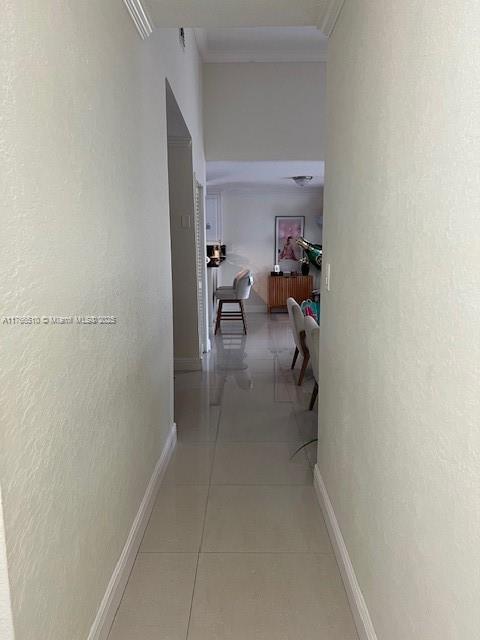 8918 SW 5th Ter, Miami, FL 33174 - hallway with light tile patterned flooring, baseboards, and crown molding