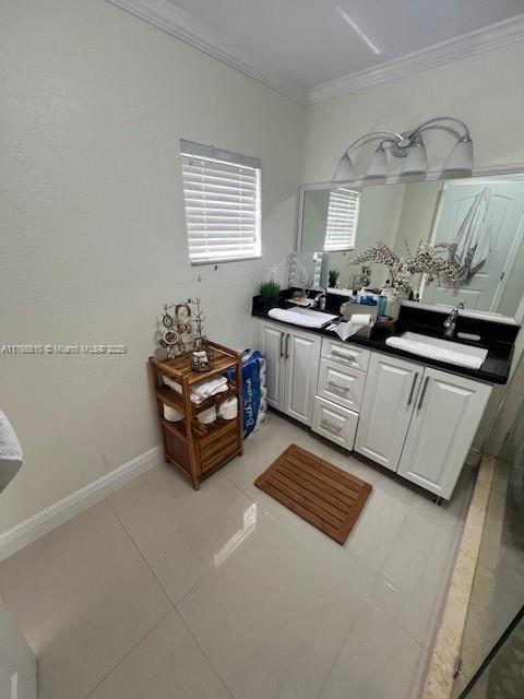 8918 SW 5th Ter, Miami, FL 33174 - full bathroom featuring a sink, tile patterned flooring, baseboards, ornamental molding, and double vanity
