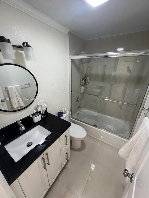 8918 SW 5th Ter, Miami, FL 33174 - full bathroom with tile patterned flooring, vanity, toilet, ornamental molding, and combined bath / shower with glass door