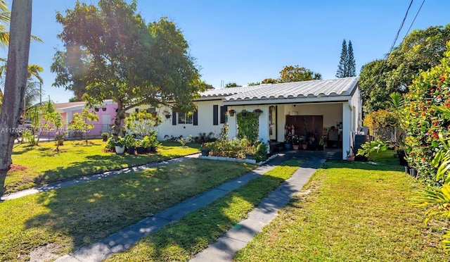 1522 NE 148th St, Miami, FL 33161 - view of front of property with stucco siding, driveway, and a front yard