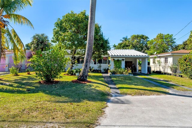 1522 NE 148th St, Miami, FL 33161 - ranch-style house featuring a front yard and an attached carport