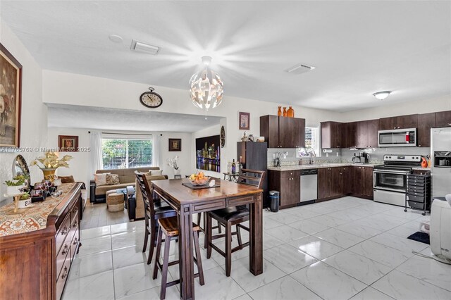 1522 NE 148th St, Miami, FL 33161 - dining area with marble finish floor, a notable chandelier, and visible vents