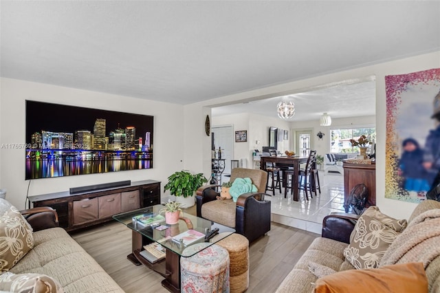 living room featuring an inviting chandelier and wood finished floors