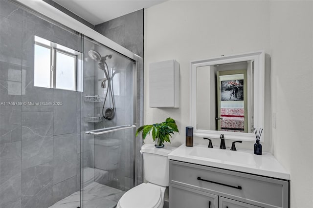 bathroom with vanity, toilet, and a stall shower