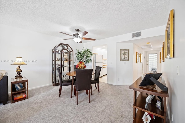 12950 SW 4th Ct Unit 309H, Pembroke Pines, FL 33027 - dining room with baseboards, visible vents, ceiling fan, a textured ceiling, and light colored carpet