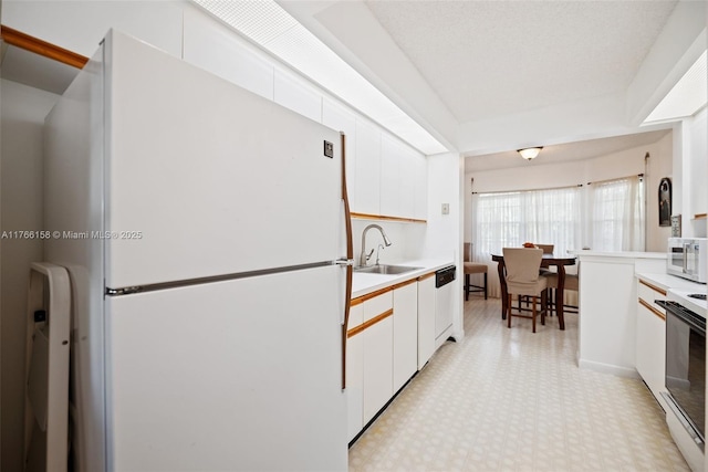 12950 SW 4th Ct Unit 309H, Pembroke Pines, FL 33027 - kitchen with white appliances, light floors, a sink, light countertops, and white cabinets