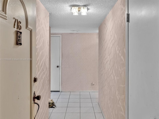 800 NE 195th St Unit 716, Miami, FL 33179 - corridor featuring light tile patterned floors and a textured ceiling