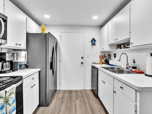 800 NE 195th St Unit 716, Miami, FL 33179 - kitchen featuring a sink, stainless steel appliances, light wood-style floors, and light countertops