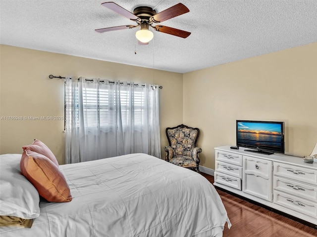 800 NE 195th St Unit 716, Miami, FL 33179 - bedroom with a textured ceiling, dark wood-type flooring, and a ceiling fan