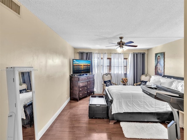 800 NE 195th St Unit 716, Miami, FL 33179 - bedroom featuring wood finished floors, visible vents, baseboards, ceiling fan, and a textured ceiling