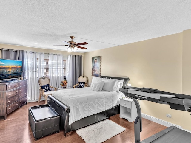 800 NE 195th St Unit 716, Miami, FL 33179 - bedroom featuring a ceiling fan, wood finished floors, baseboards, and a textured ceiling