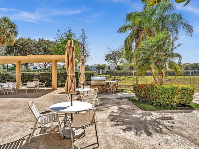 800 NE 195th St Unit 716, Miami, FL 33179 - view of patio / terrace featuring area for grilling, a grill, and fence