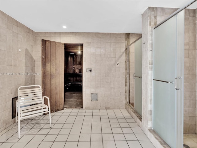 800 NE 195th St Unit 716, Miami, FL 33179 - bathroom featuring a shower stall, tile walls, recessed lighting, and tile patterned floors