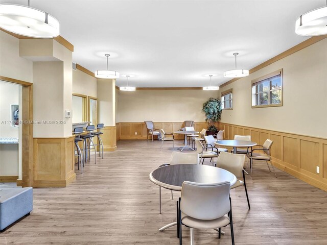 800 NE 195th St Unit 716, Miami, FL 33179 - dining room with a wainscoted wall, light wood-type flooring, and visible vents