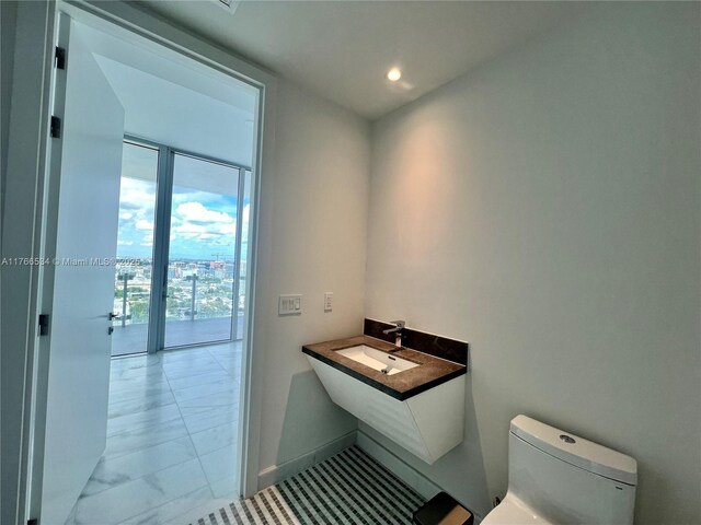 700 NE 26th Ter Unit 2205, Miami, FL 33137 - bathroom featuring floor to ceiling windows, recessed lighting, toilet, and a sink
