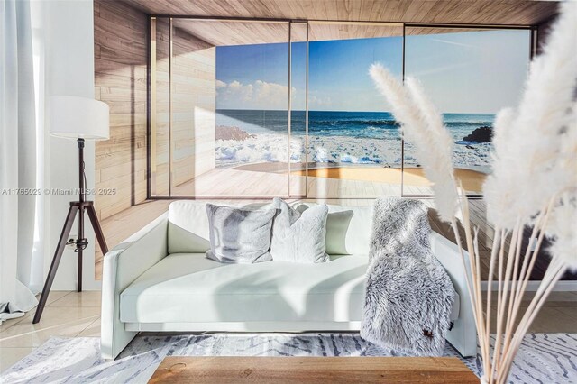 tiled bedroom featuring a view of the beach and a water view