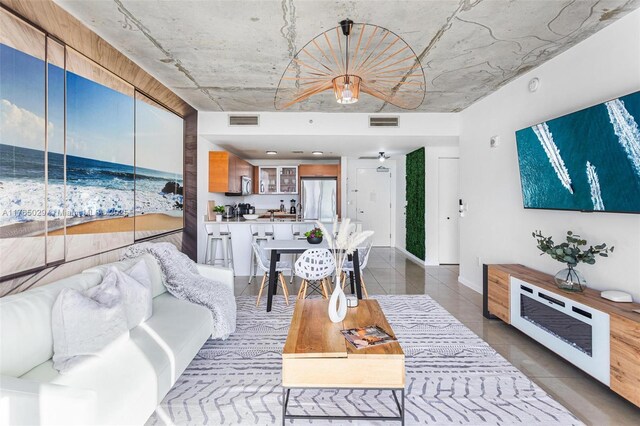 living area featuring visible vents and tile patterned flooring